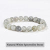 A bracelet made of natural white spectrolite stone with varying shades of gray and white.