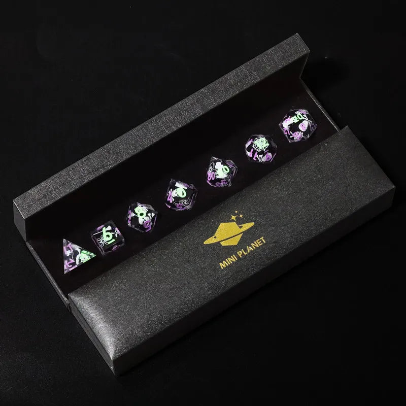 A set of six purple resin polyhedral dice displayed inside a dark gray box with a gold mini planet emblem.