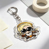 A clear acrylic keychain charm featuring an anime-style character with blonde hair and wings.