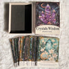 A deck of Crystals Wisdom Oracle Cards featuring a dark background and purple crystals, displayed next to a framed card and a