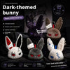 Dark-themed bunny plush toy with embroidered features and a bandage design.