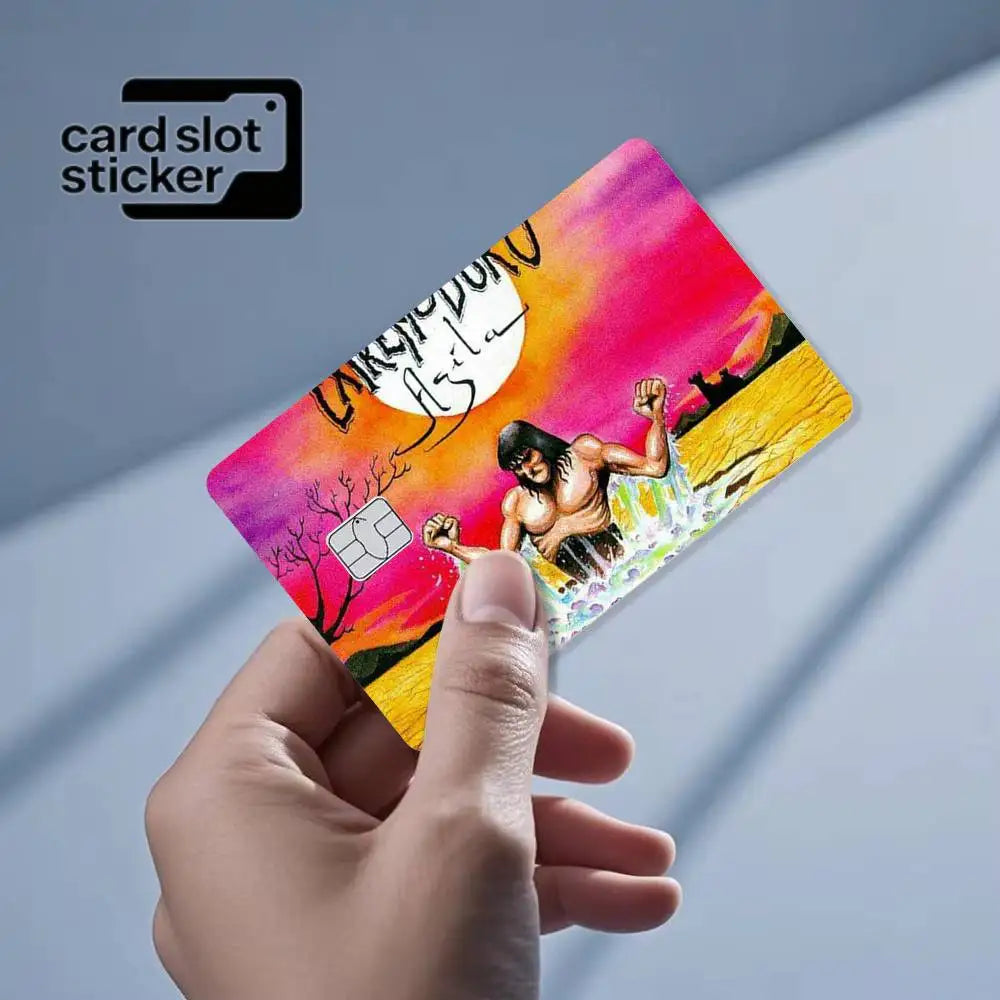 A hand holds a pink and yellow card slot sticker featuring a silhouette of a man and a moon.