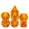 A set of seven yellow dice with red numbers, shaped like cheese, arranged in various orientations.