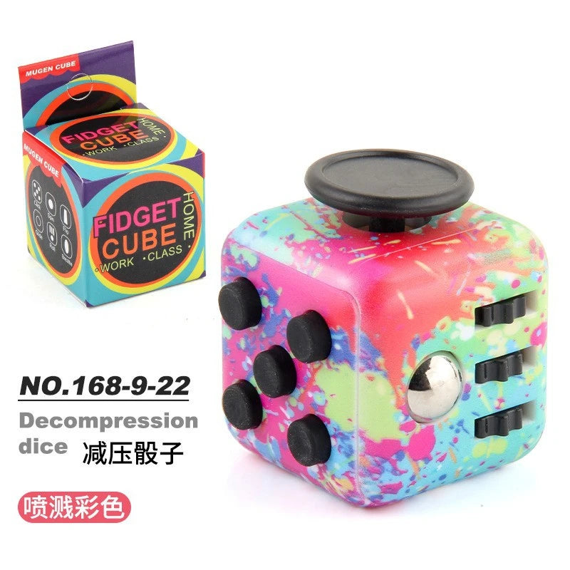 A colorful fidget cube with a rotating joystick and magnetic buttons is shown next to its packaging.