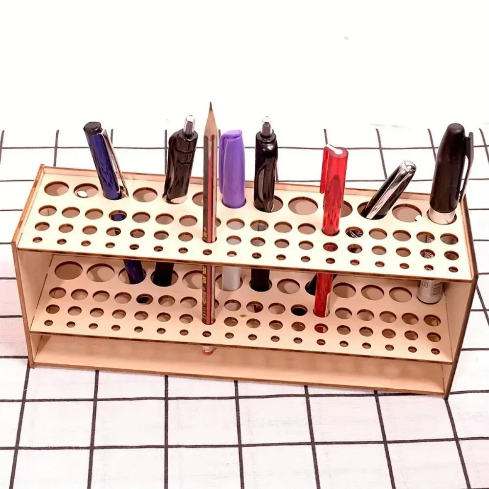 A wooden organizer holds various art brushes and pencils in individual slots for storage.
