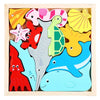 A wooden tangram puzzle board featuring colorful, cutout shapes of sea creatures like starfish, fish, and shells.