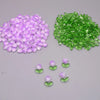 A collection of purple and green glass beads shaped like tulip flowers.