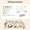 A wooden train set with various vehicles, tracks, and accessories laid out on a light wood surface.