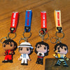 A set of keychains featuring figures of Michael Jackson in various poses and outfits attached to metal buckles.