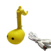 A yellow Otamatone mini electronic musical instrument toy with a white cord.