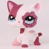 A pink and white shorthair cat bobble head figurine with glitter accents.