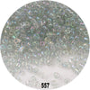 A close-up view of numerous colorful round loose glass seed beads scattered on a white surface.