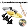 A set of clip-on mini drum cymbals including a brass and silver cymbal and a wooden mallet.