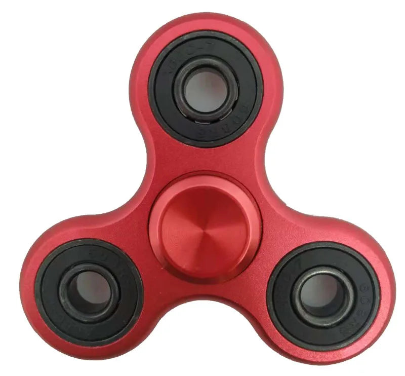 A close-up view of a red aluminum alloy fidget spinner with precision bearings.