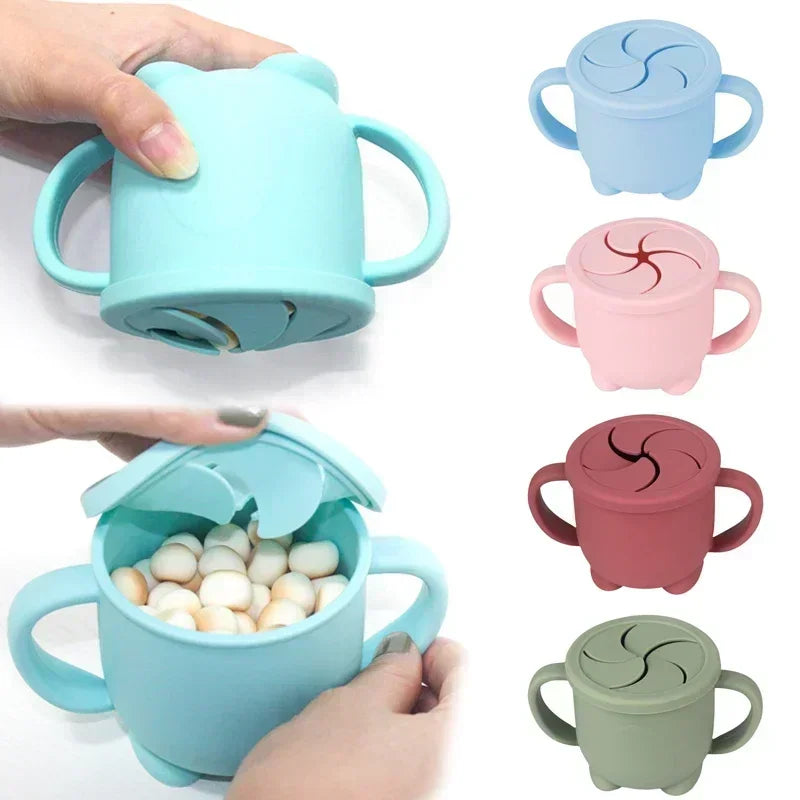 A collection of BPA-free silicone snack cups with lids in various pastel colors, held by a hand.