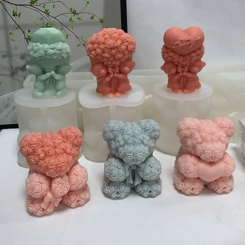 A collection of pink and green 3D bear hug silicone candle molds in various textures and shades.