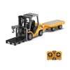 A yellow mini remote control excavator with a black cab and a yellow flatbed, shown from the side.