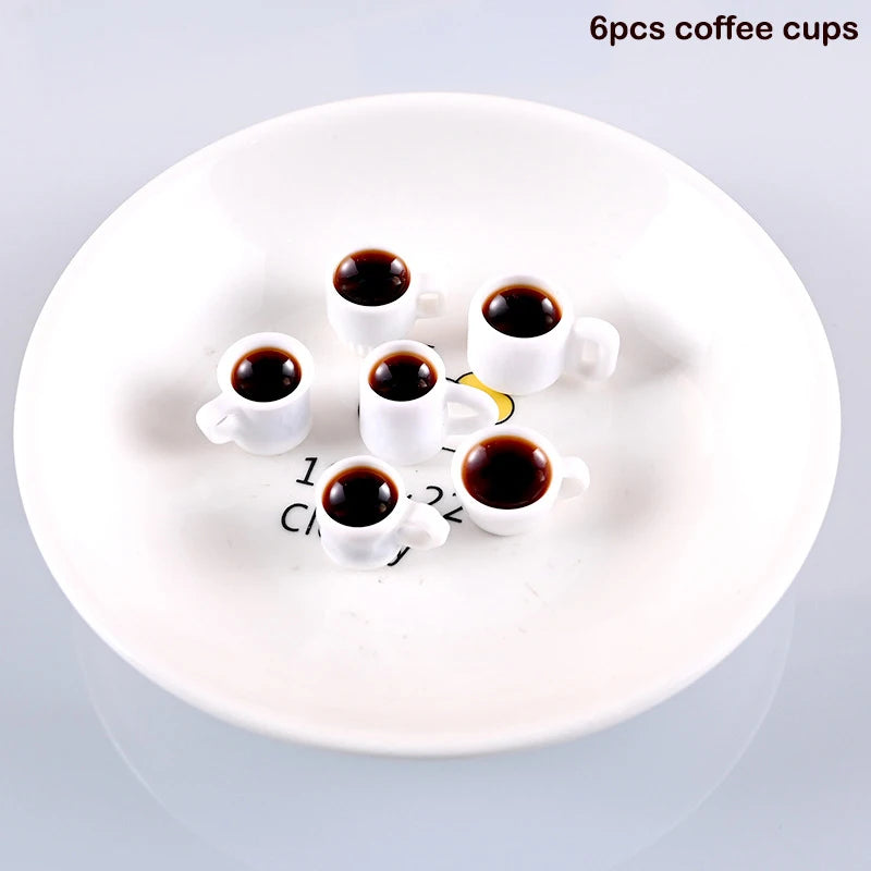 A white plate holds six mini resin coffee cups filled with dark liquid for dollhouse kitchens