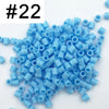 A pile of 1000 small blue plastic fuse beads for creative craft projects.