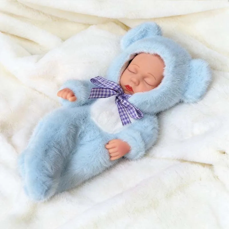 A realistic soft vinyl baby doll wearing a light blue fuzzy outfit and a purple bow, lying on white fur.