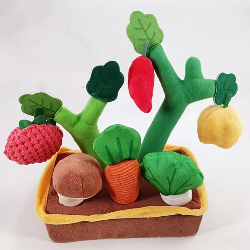 A set of green and red plush toys resembling plant parts, including leaves, stems, and fruit, displayed in a brown tray.