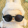 A Labubu doll wearing a white fluffy hoodie and black sunglasses.