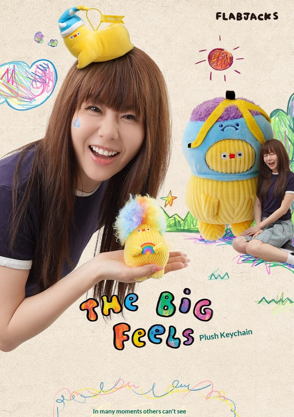 A woman holds a yellow banana-shaped plush keychain with purple and blue accents against a light background.