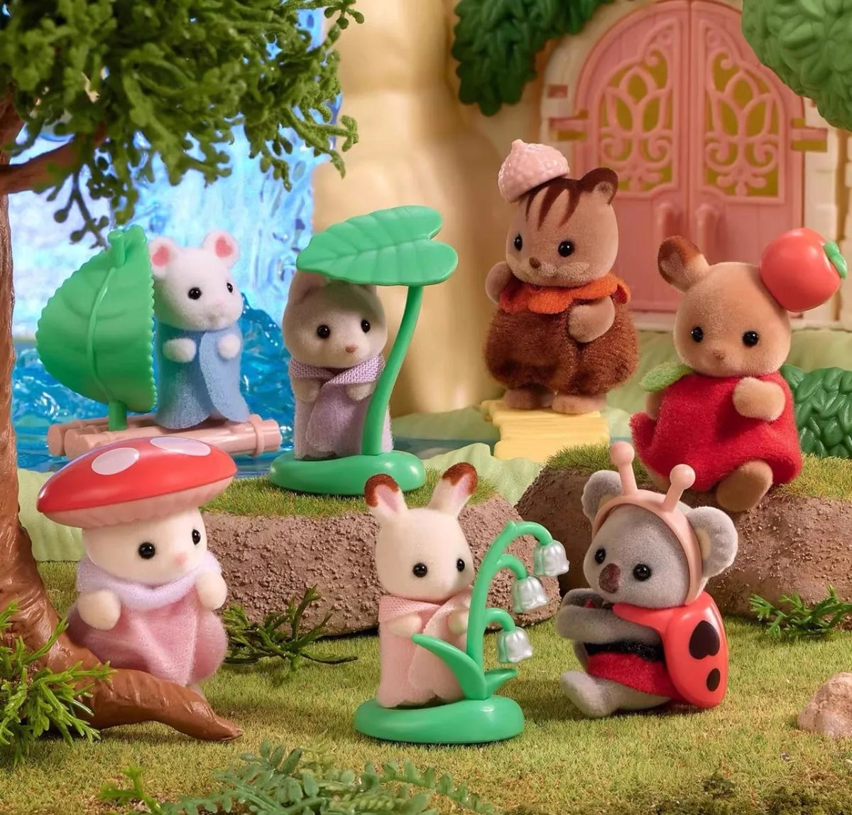 A collection of Sylvanian Families figures including a bear, a rabbit, and a hedgehog in a natural outdoor setting.