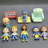 A collection of playful cartoon PVC figurines featuring various characters and a watermelon school bus design.