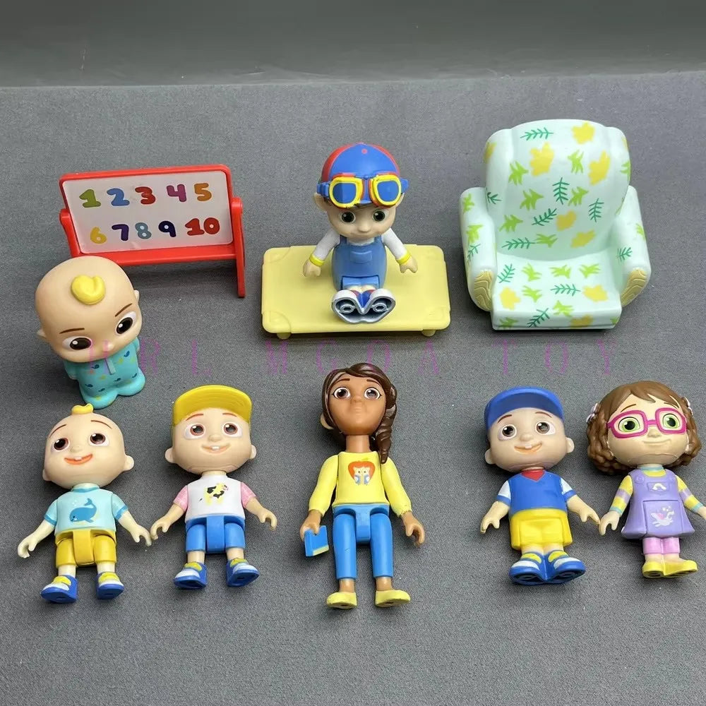 A collection of playful cartoon PVC figurines featuring various characters and a watermelon school bus design.
