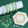 A stack of colorful clay and alphabet beads with a gold bracelet displayed on a white square background.