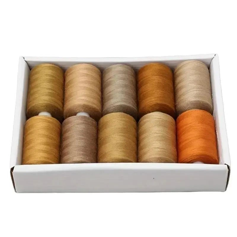 A box containing assorted brown shades of polyester sewing thread spools.