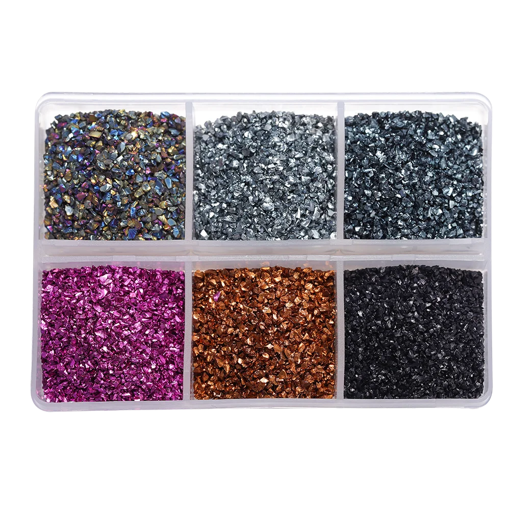 A clear plastic tray filled with various colors of crushed glass stones for resin and craft projects.