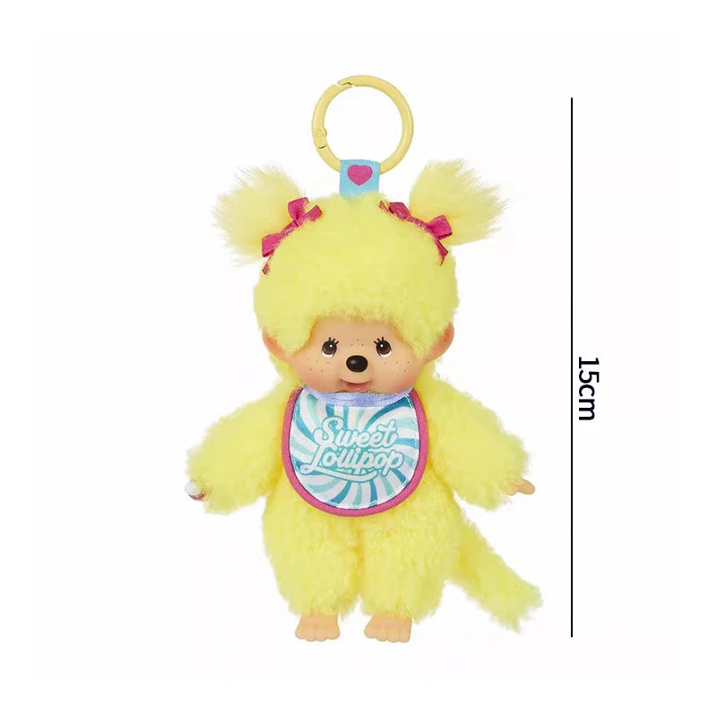 A yellow fluffy cartoon plush toy with a heart charm hanging from a gold loop.