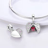 A silver heart charm bead with pink zircon stones is displayed on a silver chain.
