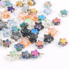 A collection of iridescent glass star spacer beads in various colors and shades for jewelry making