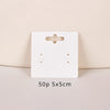 A white square jewelry display card with a cutout and two holes is shown on a light background.