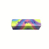 A rectangular block of salted butter squishy stress relief toy with a vibrant purple and yellow gradient color.