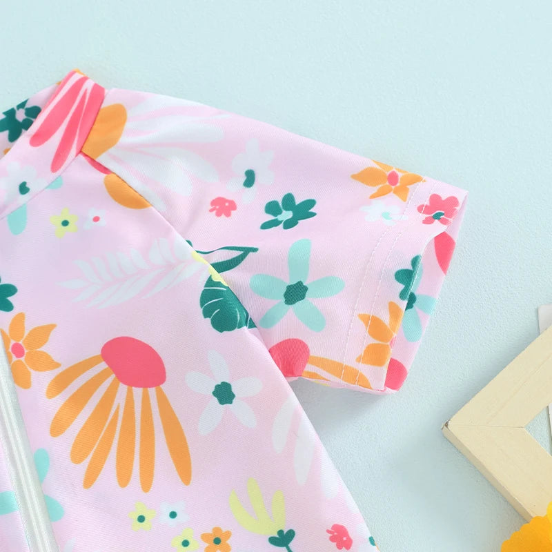 Pink baby rash guard swimsuit with floral patterns and short sleeves