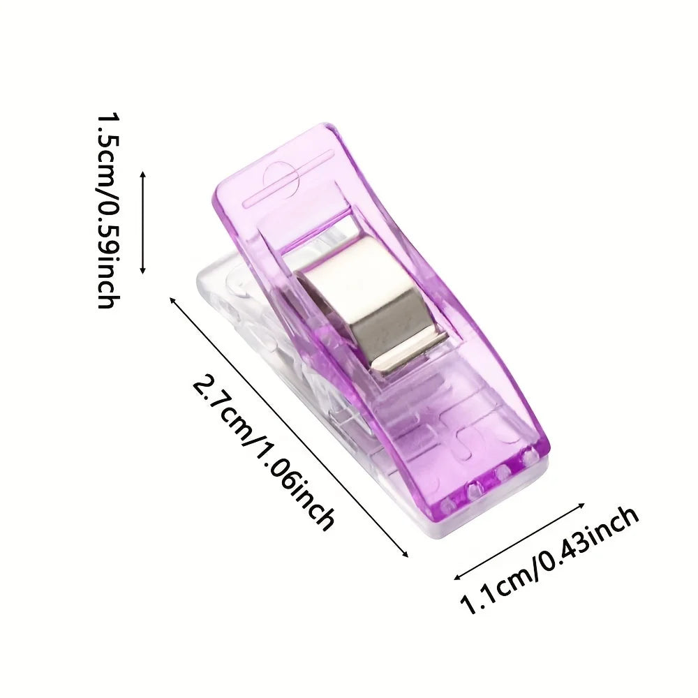 A plastic diamond painting clip in purple with a silver square piece, shown from the side.