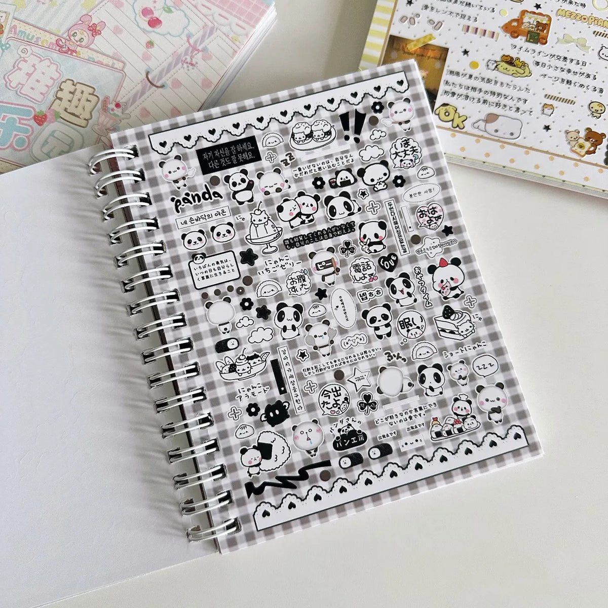 A spiral-bound sticker book filled with various cute and kawaii designs for journaling and scrapbooking