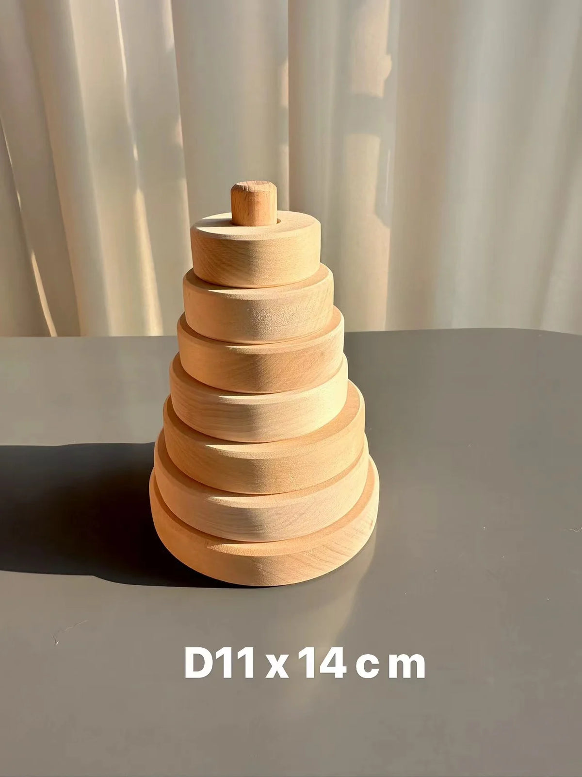 A stack of light wood circular blocks, used for stacking or play.