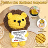 Handwoven knitted yellow lion doll with a positive message card