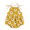 Yellow cotton romper for a baby girl with a white daisy floral print and adjustable ties