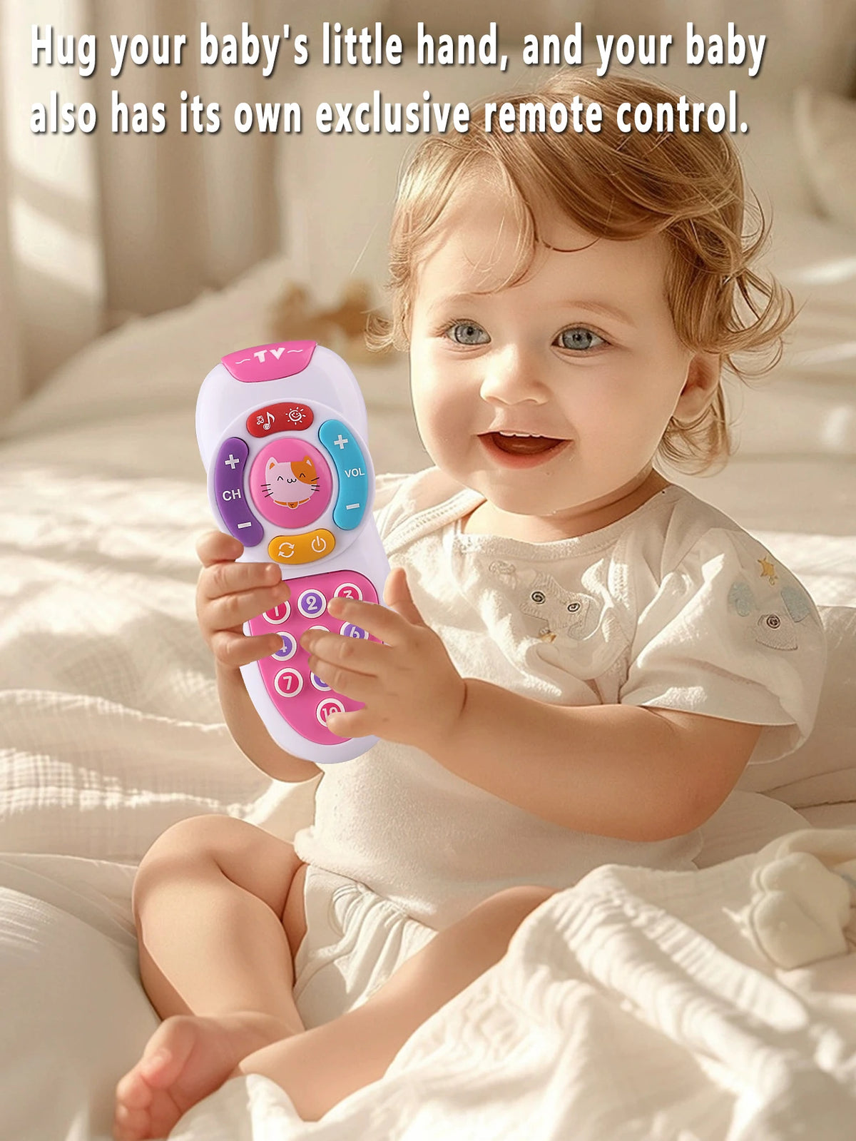 A smiling baby is holding a pink electronic remote control toy with lights and music.