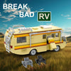 A yellow Breaking Bad RV model kit built from building blocks, shown outdoors in a grassy field.