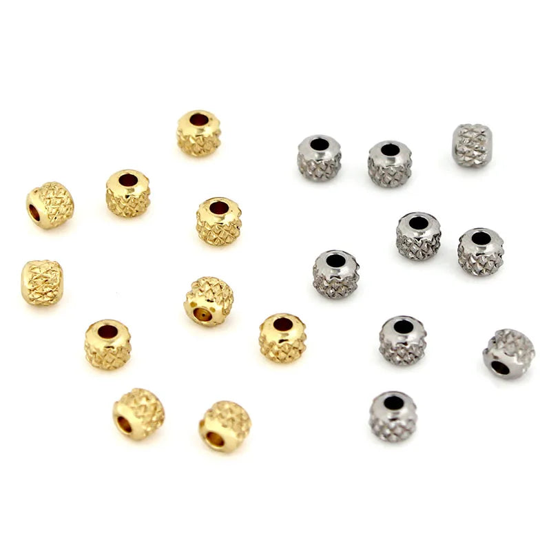 A collection of gold stainless steel round spacer beads for jewelry making displayed on a white background.