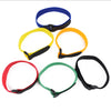 A set of five nylon bike handlebar straps in blue, yellow, orange, and red, each with a black grip.