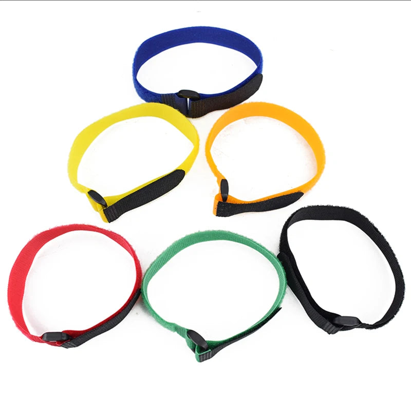 A set of five nylon bike handlebar straps in blue, yellow, orange, and red, each with a black grip.