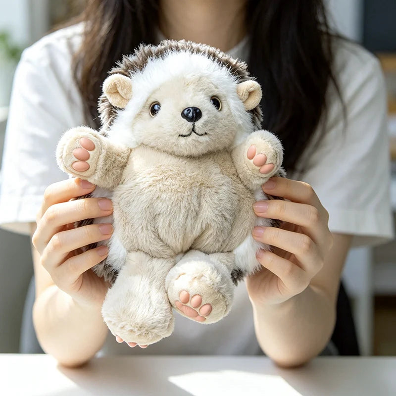 A person is holding a light beige and white cute hedgehog plush pillow.